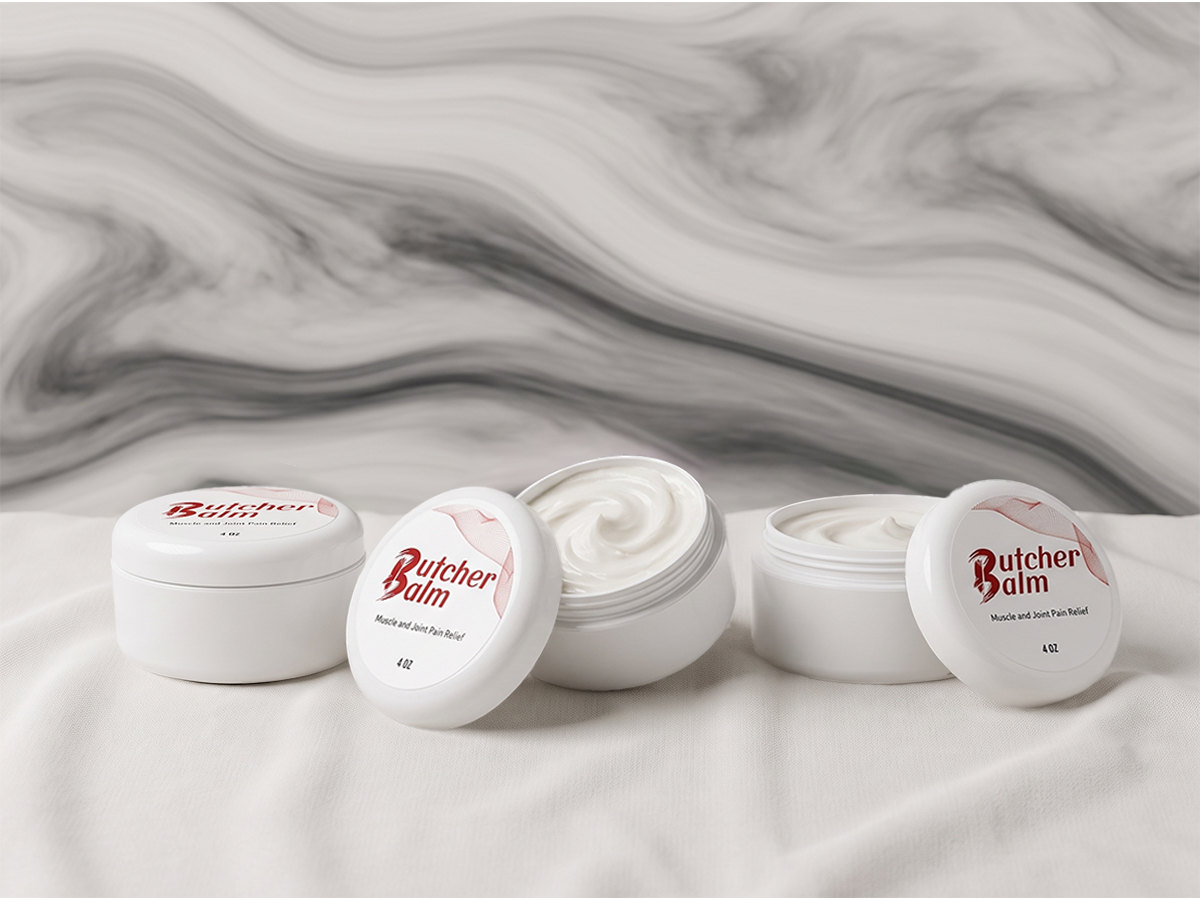 Butcher Balm 4oz jars on silk, one open