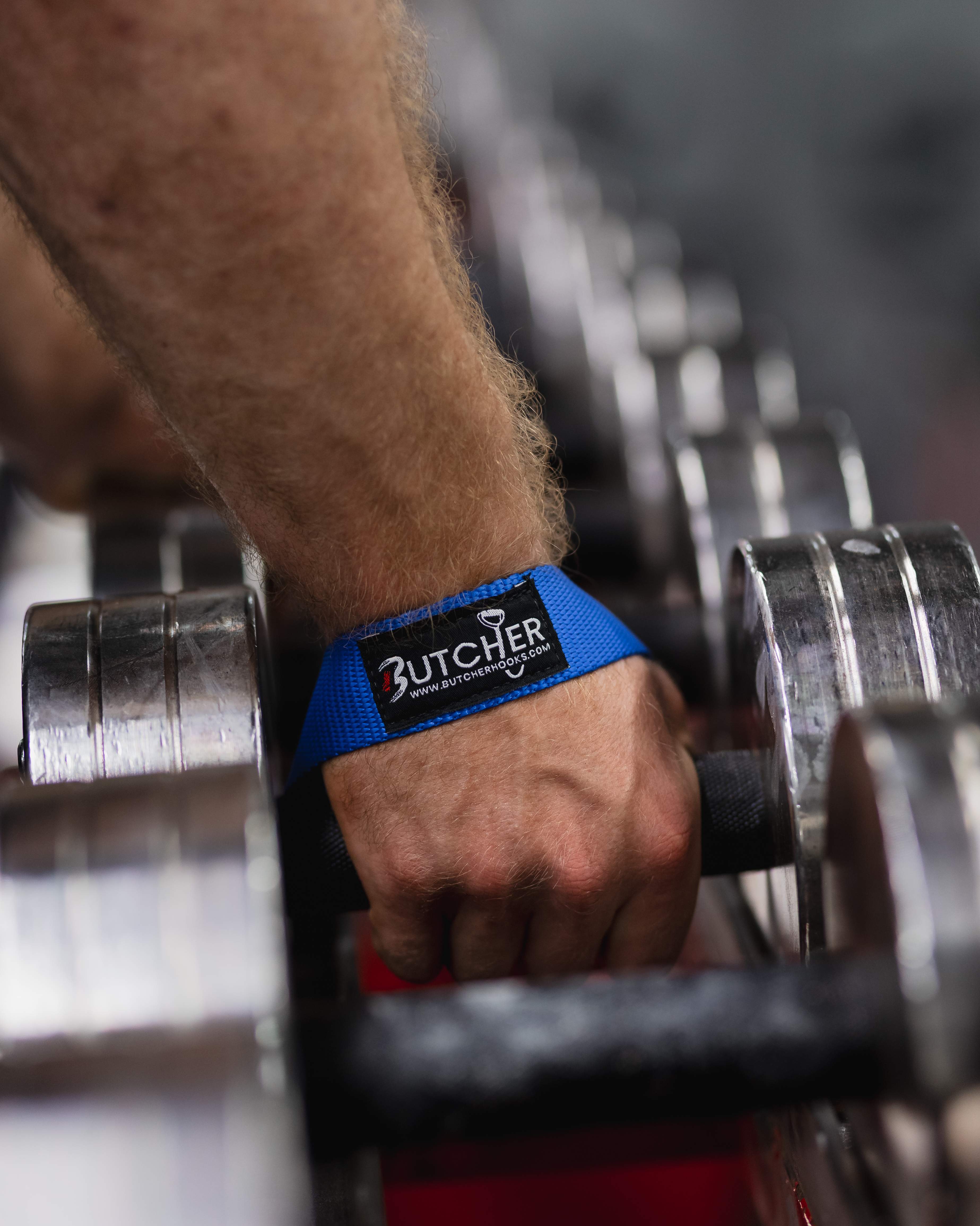 Blue Butcher lifting straps on a chrome dumbbell